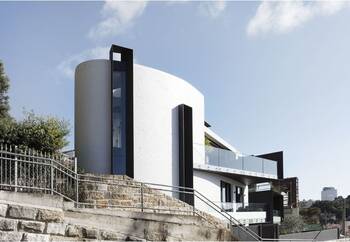 Contrasting Facade: White Curvilinear Volumes and Black Verticals on Terraced Terrain