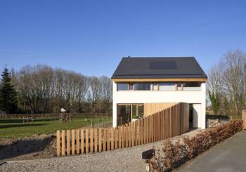 Eco-minimalism: Modern House with Wooden Facade Elements and Solar Panels