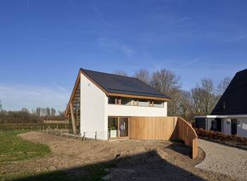 Modern minimalist façade with wooden accents and asymmetrical roofing