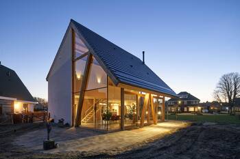 Modern house with asymmetrical glass facade and dynamic gabled roof