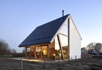 Modern minimalist house with triangular facade and panoramic glazing