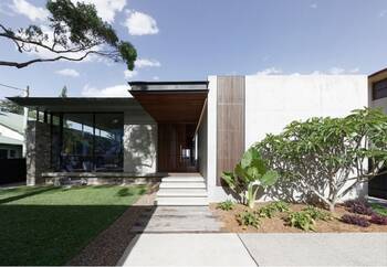 Minimalist facade of a modern house with contrasting textures and wooden accents