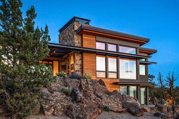 Modern mountain home with combined stone and wood facade