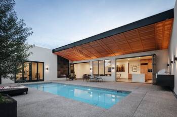 Minimalist Facade with Wooden Veranda Ceiling and Open Pool