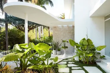 Tropical Minimalism: Snow-White Facade with Exotic Greenery Integration