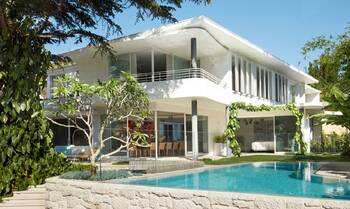 Modern villa with minimalist white facade and panoramic glazing