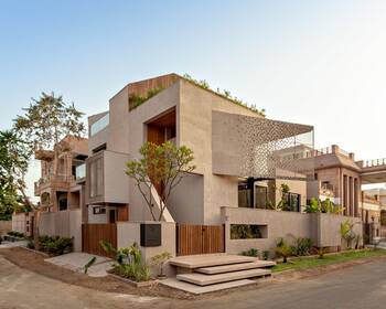 Modern Minimalist Facade with Perforation and Integrated Greenery