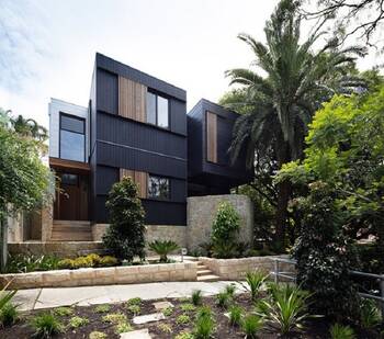 Modern house with contrasting dark facade and wooden accents