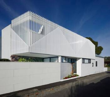 White Minimalist Facade with Vertical Louvers