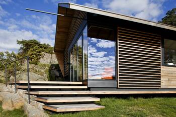 Modern minimalist facade with wooden louvers and panoramic glazing