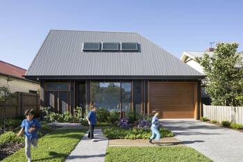 Modern façade with contrasting metal and wood combination under an unusual pitched roof