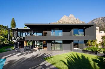 Modern minimalist facade with contrasting dark gray panels and glass