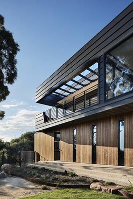 Modern two-level facade with contrasting wood and metal combination