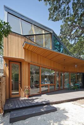 Modern wooden facade with asymmetrical roof and panoramic glazing