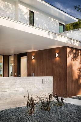 Modern two-tone facade with contrasting white panels and wooden cladding