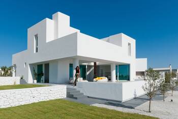 Snow-white minimalist facade with cubic volumes
