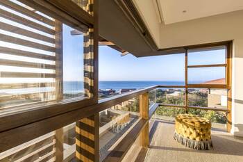 Modern panoramic interior with ocean view: an elegant combination of wood and glass