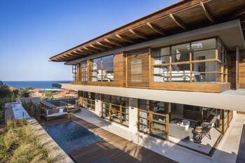 Modern coastal house with wooden facade and panoramic glazing