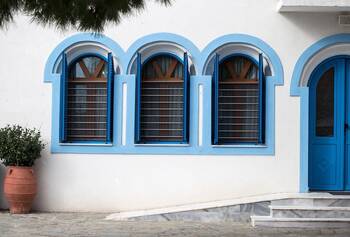 Mediterranean Façade with Blue Arched Windows