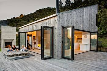 Modern wooden facade with sliding glass doors and asymmetric roof
