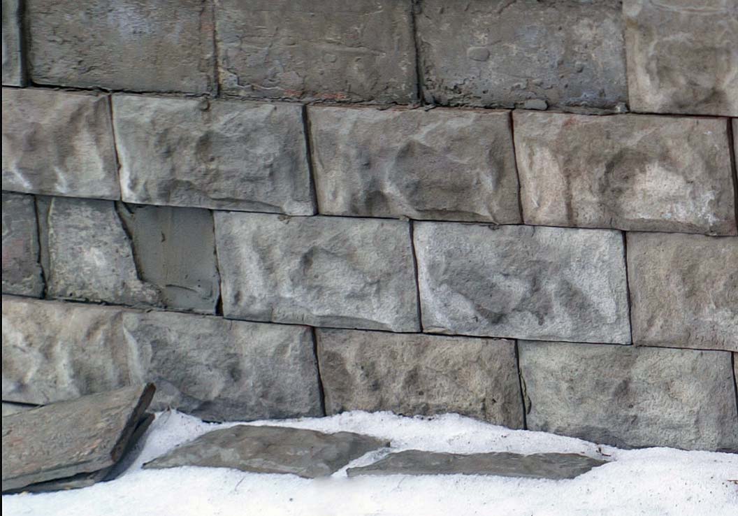 The artificial stone tile has fallen away from the plinth due to water penetration