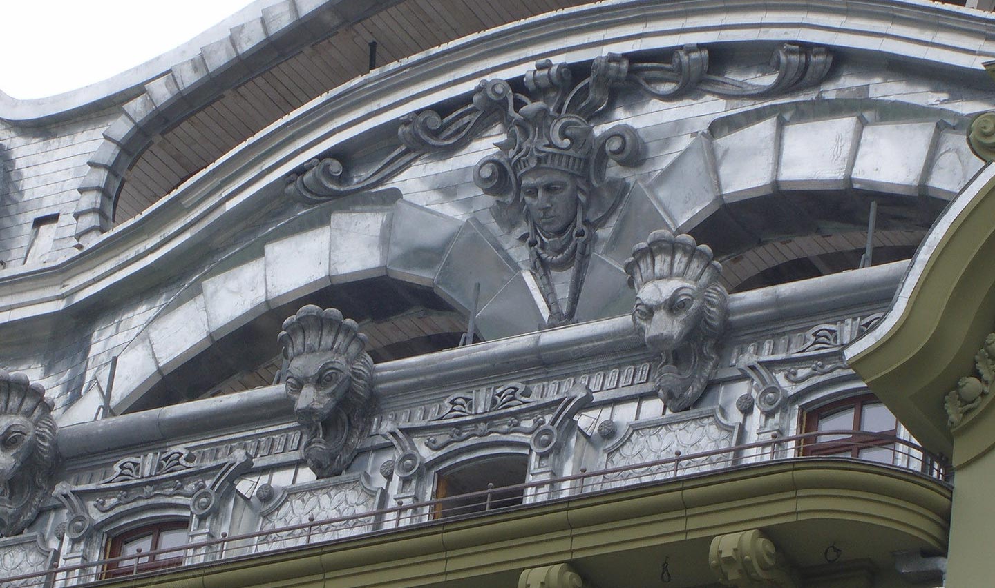 Mascarons and embossed metal decorations on the facade