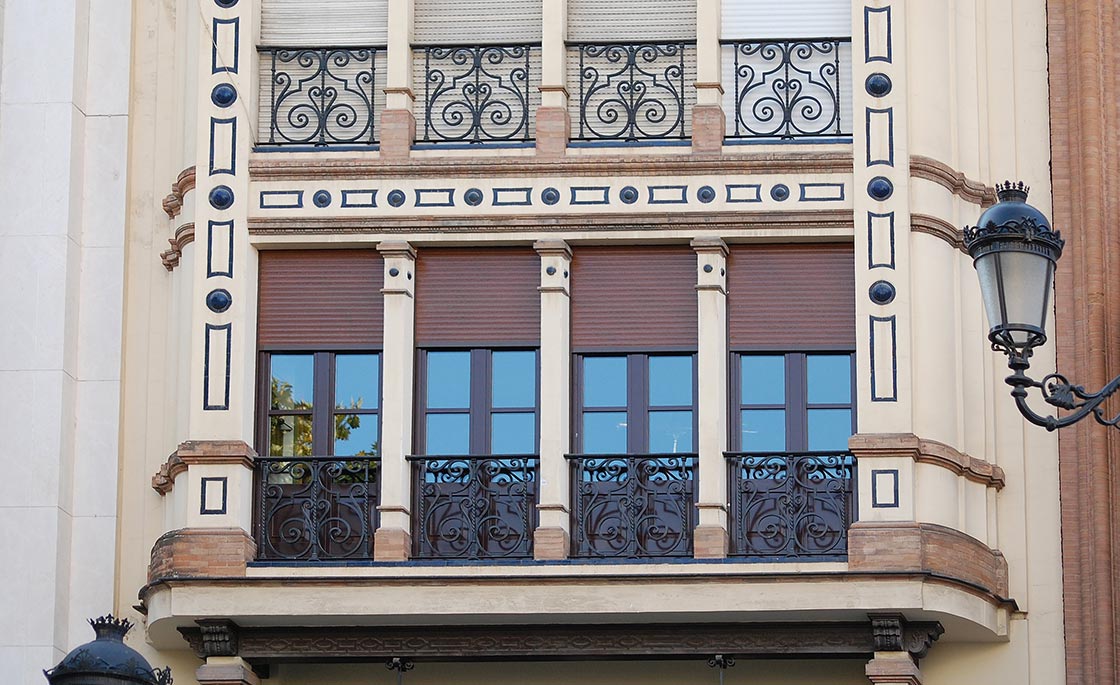 Facade with wrought iron and metal elements in Seville, Spain