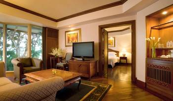 Tropical Elegance: Suite Interior with Colonial Motifs and Panoramic Glazing