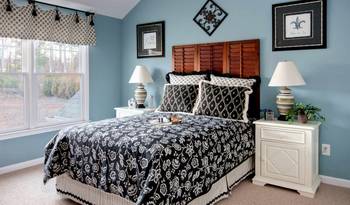 Harmonious French Country Bedroom with Turquoise Walls and Wooden Headboard