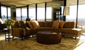 Elegant living room with panoramic windows: a fusion of minimalism and natural warmth