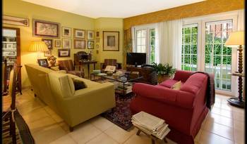 Cozy Classic: Eclectic Living Room with Art Gallery Wall and Panoramic View in a Country House