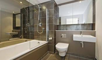 Elegant monochrome bathroom with contrasting texture combinations