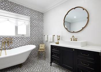 Elegant bathroom with patterned tiles and vintage accents