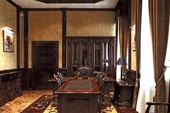 Classic office with dark wooden panels and refined furniture