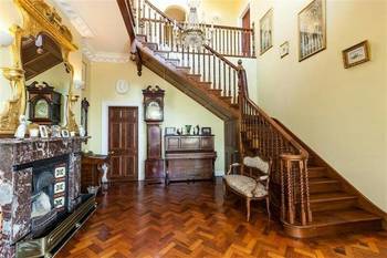 Classic Victorian Hall with Majestic Staircase and Antique Decorative Elements