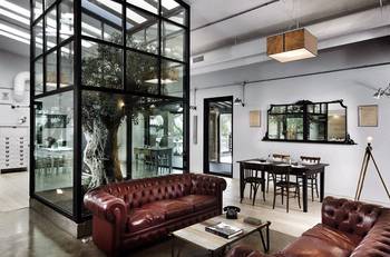 Industrial Classic: Interior with an Olive Tree in a Glass Cube