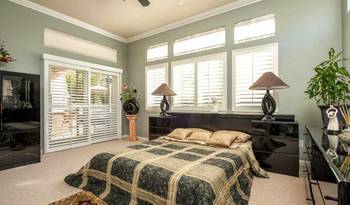 Elegant Country House Bedroom: Harmony of Light Green Walls and Classic Details