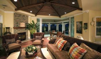 Sophisticated country house interior with wooden vaulted ceiling and panoramic glazing