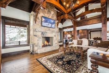 Luxurious Mountain Chalet: Harmony of Wood and Stone in an Interior with Exposed Beams and Panoramic Facade