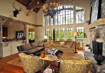 Rustic Elegance: Double-Height Living Room with Panoramic Windows and Stone Fireplace