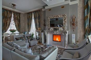 Neoclassical living room with emphasis on luxurious fireplace in gray-blue tones