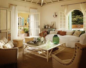 Mediterranean Elegance: Light-Filled Interior with Arched Windows and Exposed Beams