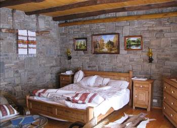 Interior of bedroom in cottage in Craftsman style.