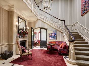 Classical Elegance: Sophisticated Country House Hall Interior with a Central Curved Staircase