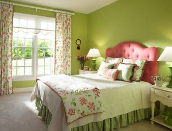 Romantic country interior with contrasting combination of green walls and pink headboard