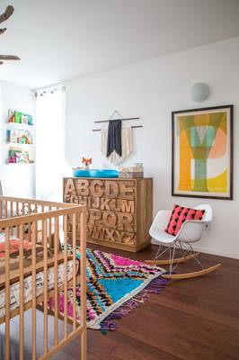 Modern Nursery: Alphabet Dresser and Vibrant Accents in a Minimalist Space