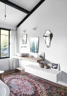 Minimalist bathroom with eclectic accents and vintage rug