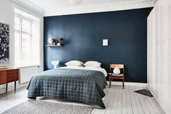 Scandinavian Minimalism: Deep Navy Accent Wall as Bedroom Focal Point