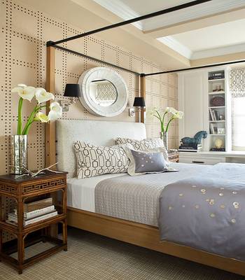 Elegant Bedroom with Perforated Wall Panels and Minimalist Four-Poster Bed