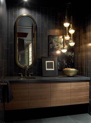 Dramatic dark bathroom with gold accents and wooden elements